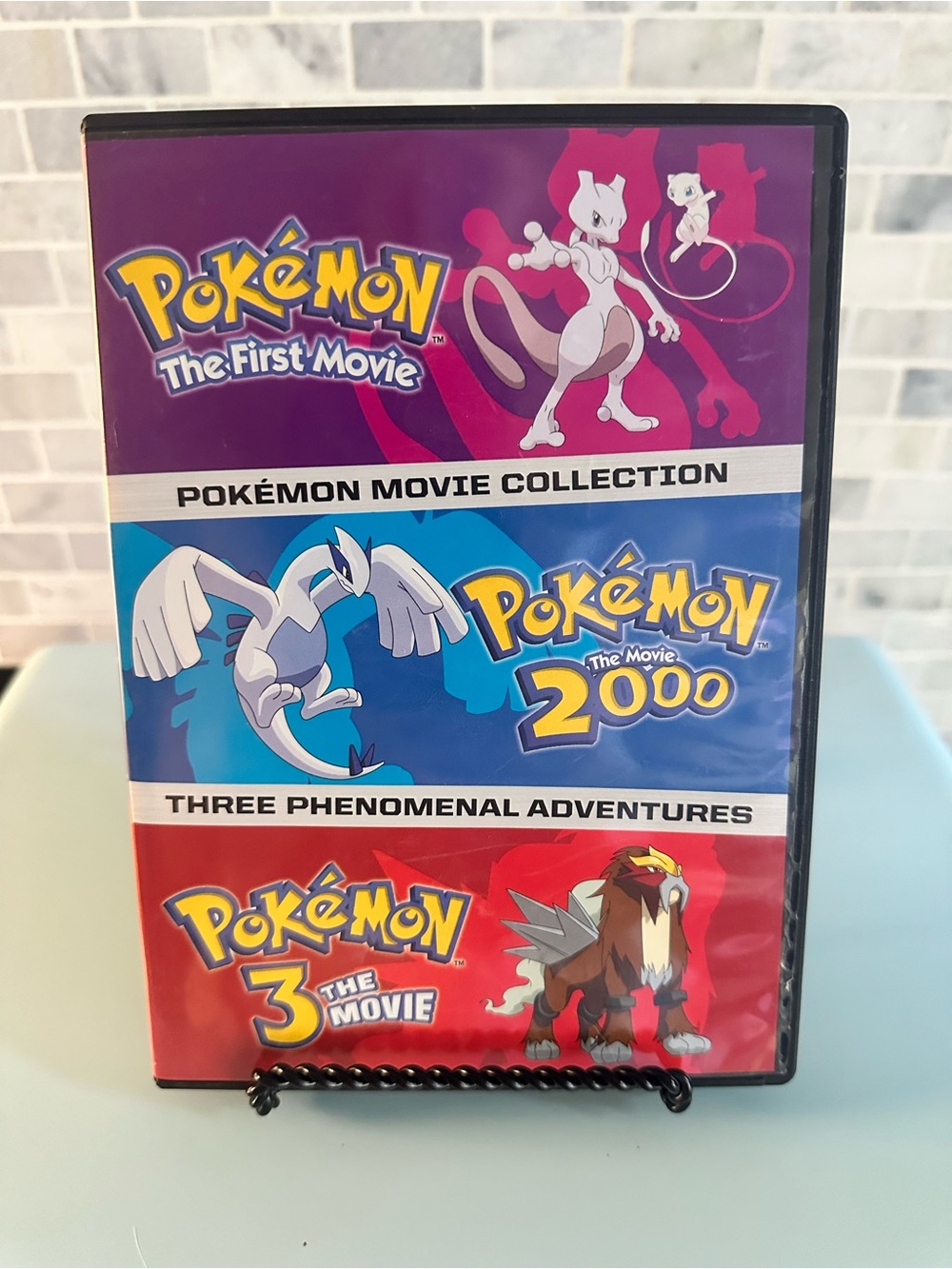 Pokemon Movie Collection – Purple, Blue, Red Cover Art
